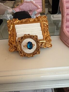 Gold Ornate Jewelry Display with Blue Accent